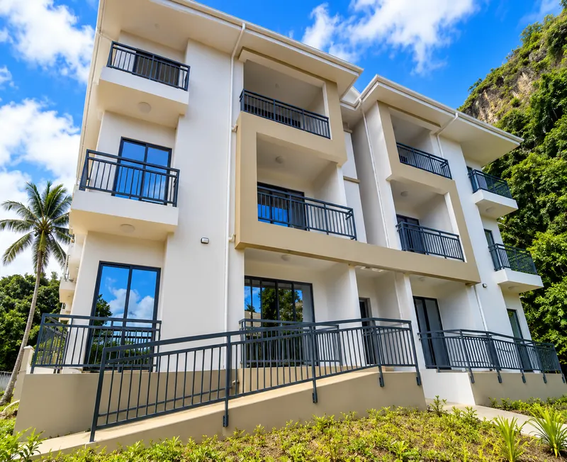 Modern white apartment building under blue sky
