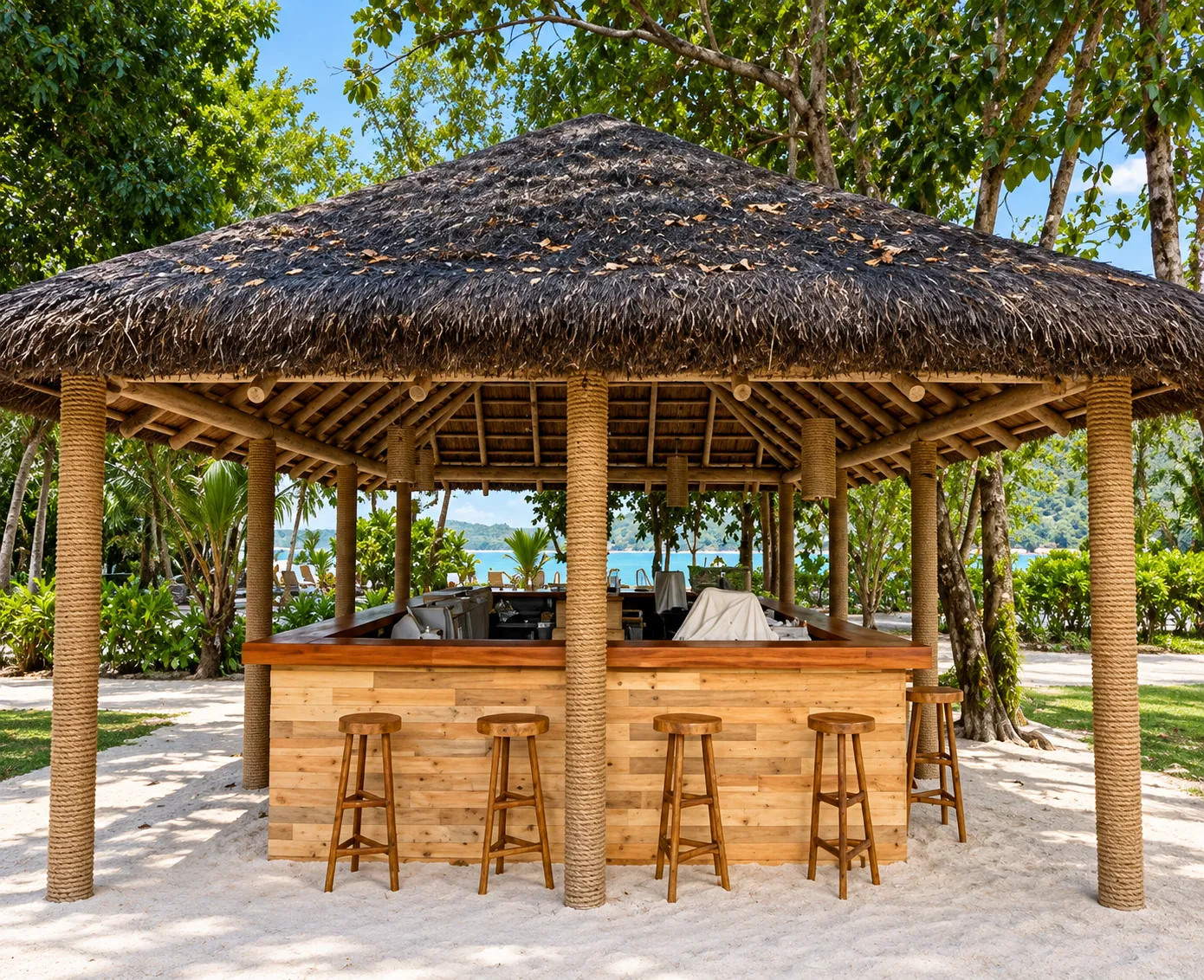 Thatched beach bar pavilion with timber counter and stools