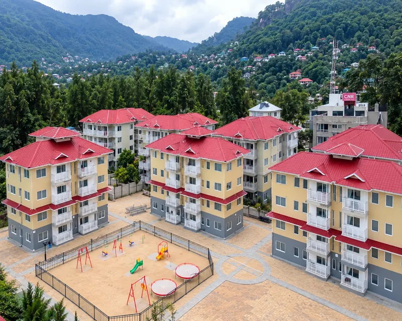 Aerial view of red-roofed public housing blocks around a playground