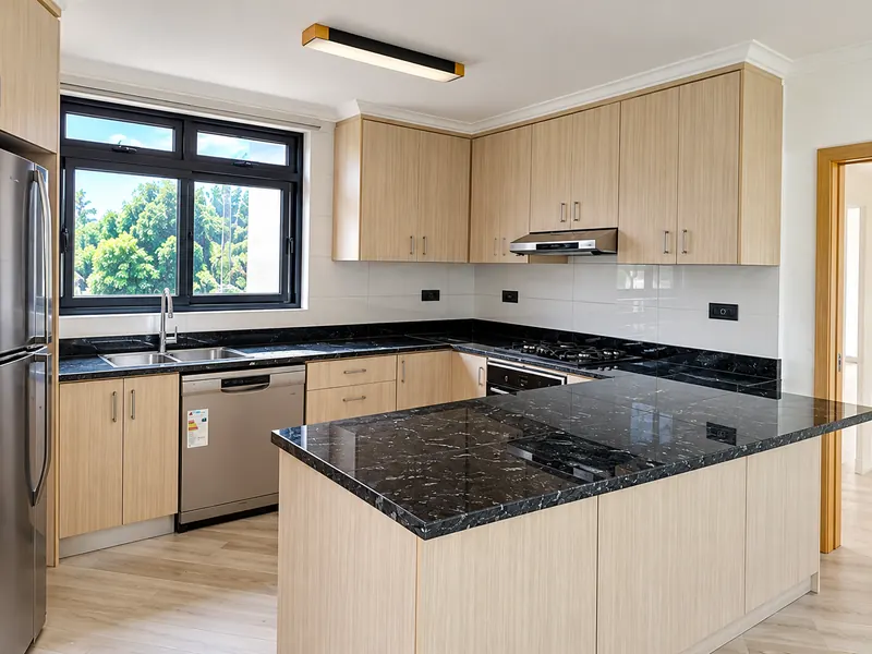 Light-wood kitchen with dark marble island