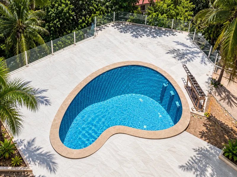 Freeform villa pool on a stone terrace